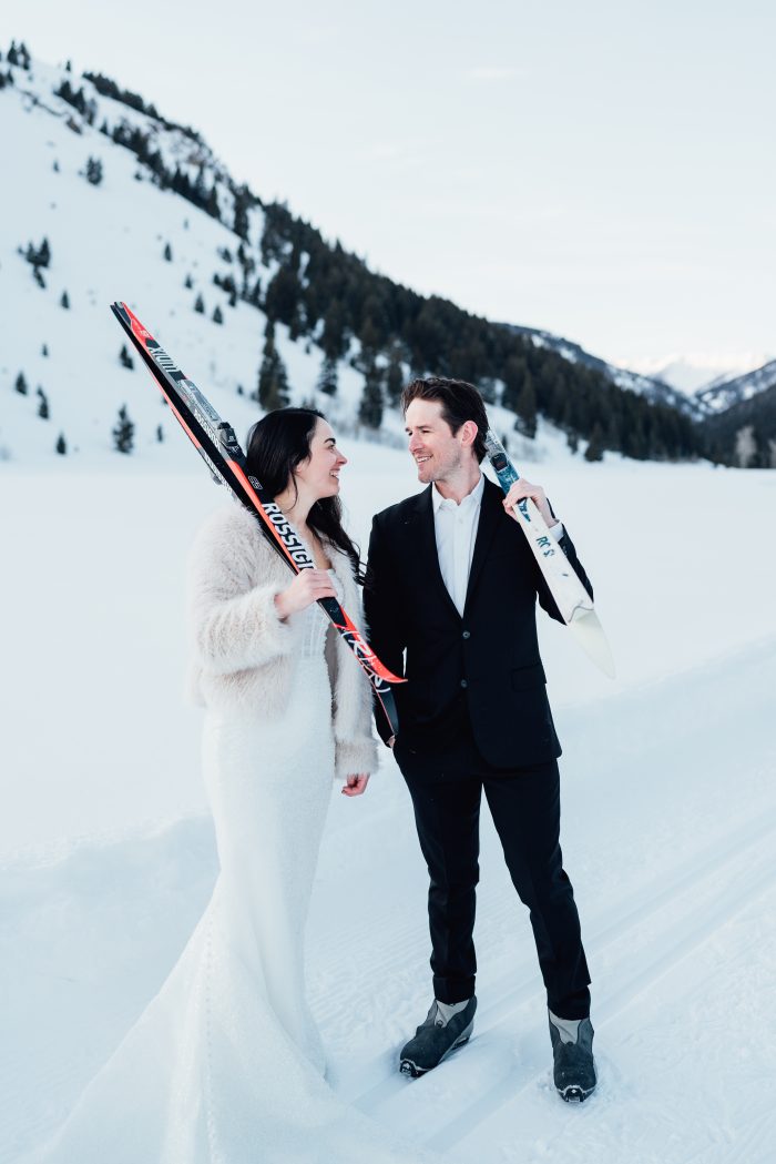 Bride wearing Drew by Maggie Sottero skiing with her husband