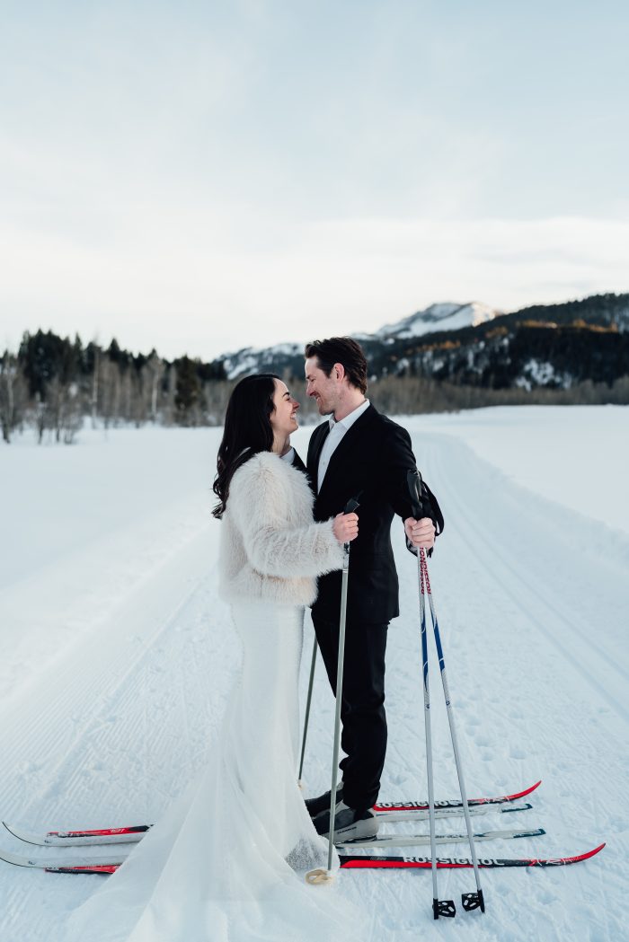 Bride wearing Drew by Maggie Sottero skiing with her husband