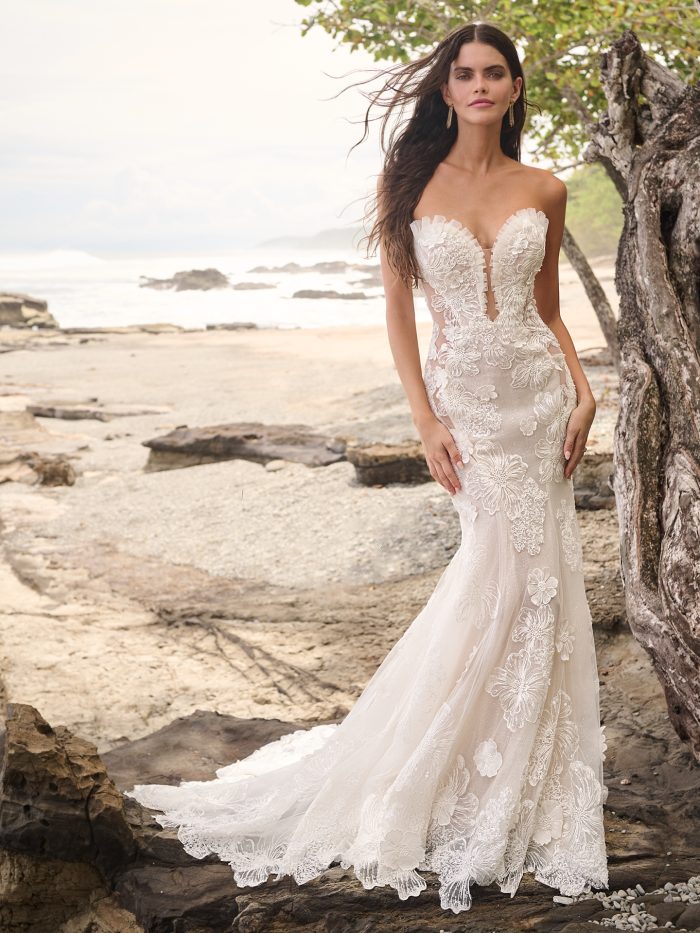 Bride wearing Mohave wedding gown by Sottero and Midgely that pairs well with pear engagement rings