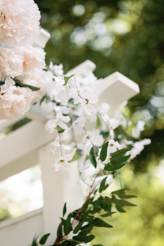 Budget-friendly floral decor on a wedding arch
