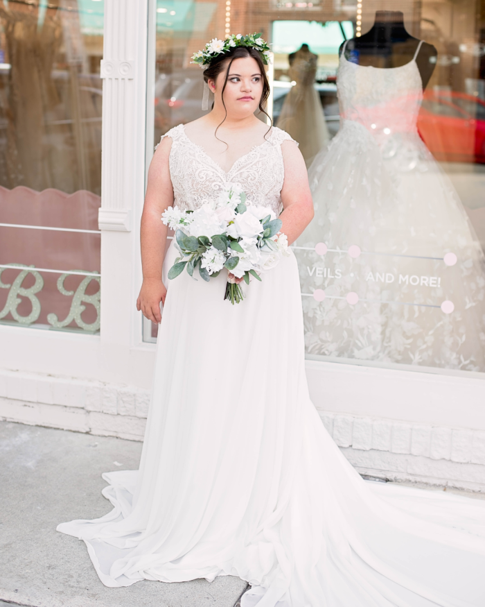 Bride trying out wedding dress shopping tips while wearing a Maggie Sottero gown.