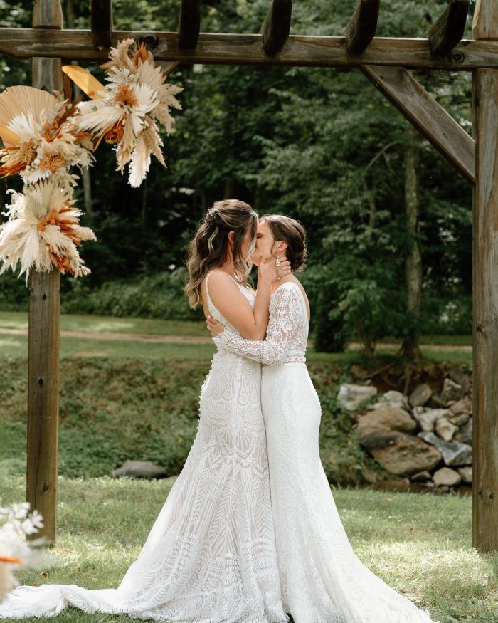 Bride wearing Drita wedding dress by Maggie Sottero and kissing her wife.