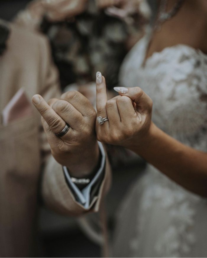 A couple showing off their rings