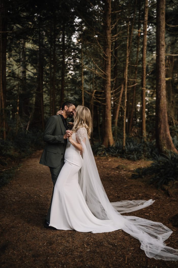 A bride wearing Summer crepe fabric wedding dress by Sottero and Midgley kissing her husband