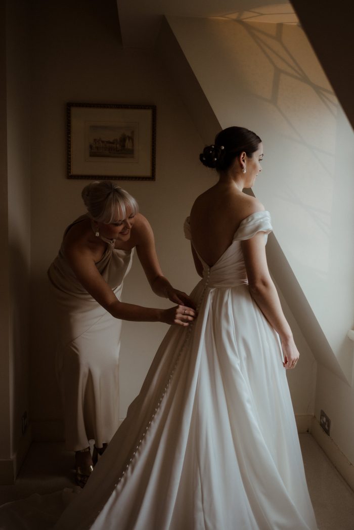 Mother of the bride fixes her daughter's wedding dress, Scarlet by Maggie Sottero