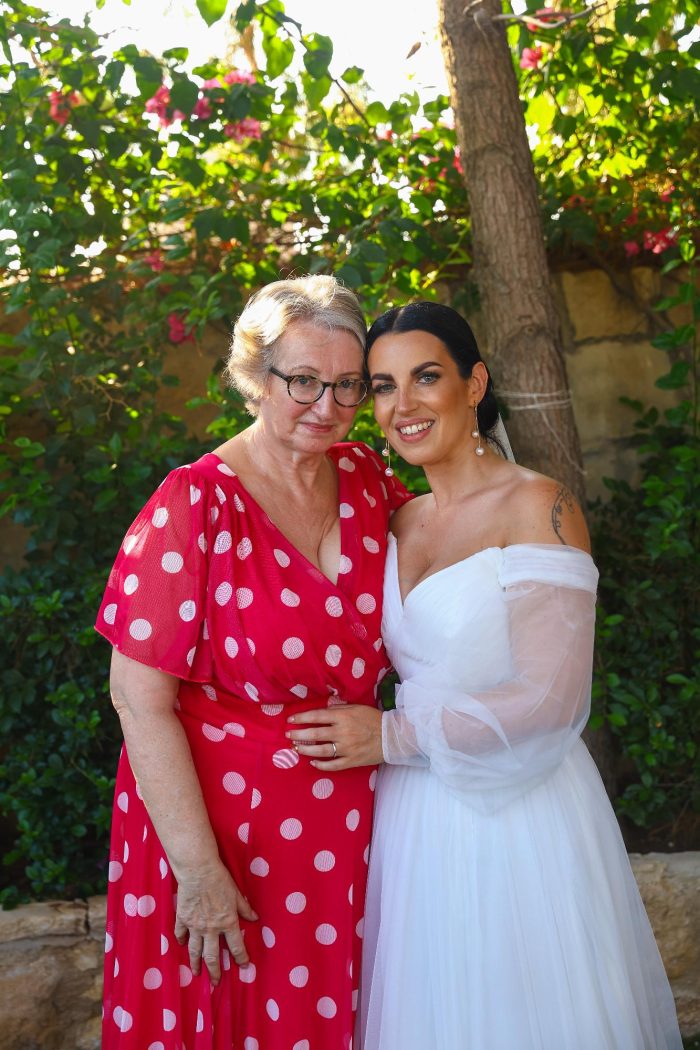 Bride wearing Nerida by Sottero and Midgley hugs the mother of the bride