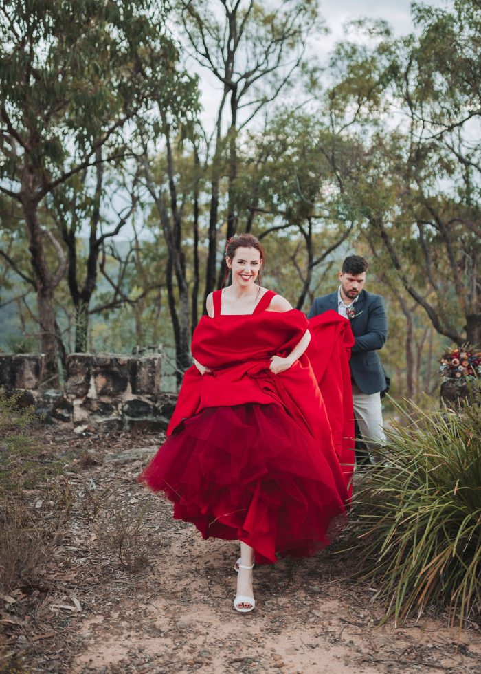 Bride wearing red wedding dress Alera by Sottero and Midlgey instead of white, which is a wedding tradition