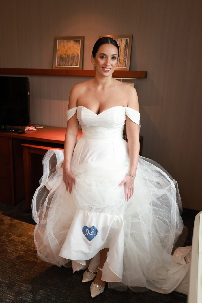 Bride wearing Anniston by Maggie Sottero with a patch for her father as a wedding tradition