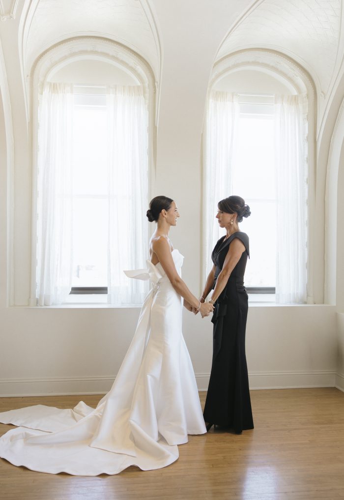 Gabrielle wearing Mitchell by Maggie Sottero embracing the mother of the bride
