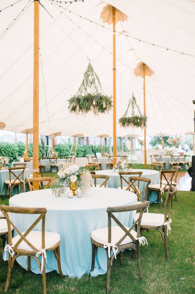 Large tent wedding venue with a blue and orange theme