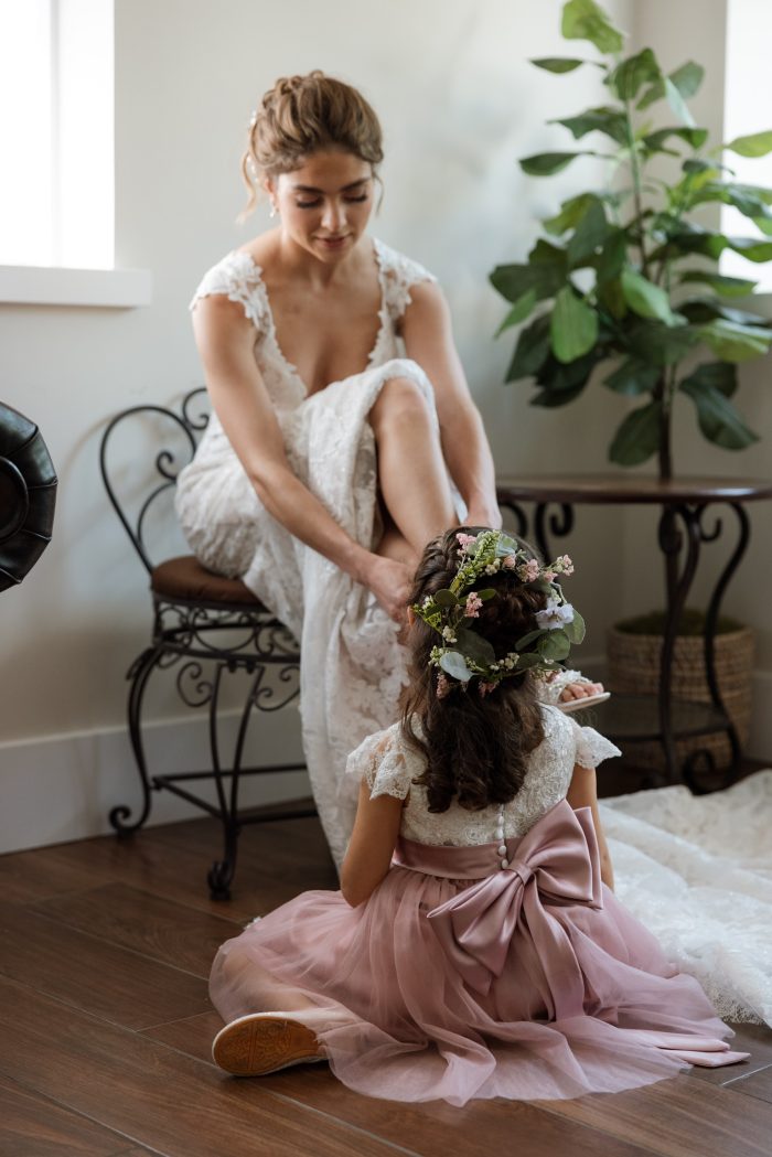 Bride wearing a Maggie Sottero wedding dress with her flower girl