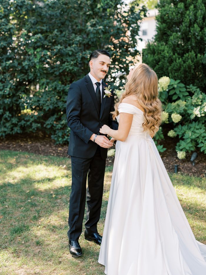 Bride wearing Ekaterina wedding dress by Maggie Sottero does a first look with her husband as a new wedding tradition