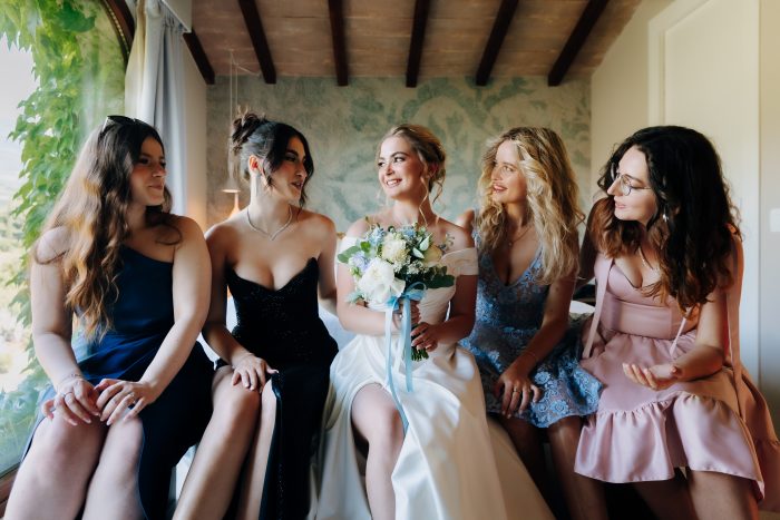 Bride wearing Ekaterina by Maggie Sottero surrounded by bridesmaids in mismatching dresses as a new wedding tradition