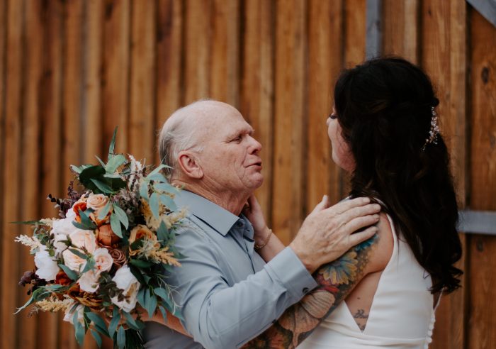 Bride hugging her father in new wedding tradition