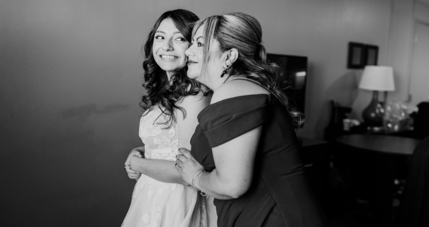 Real bride is hugged by the mother of the bride