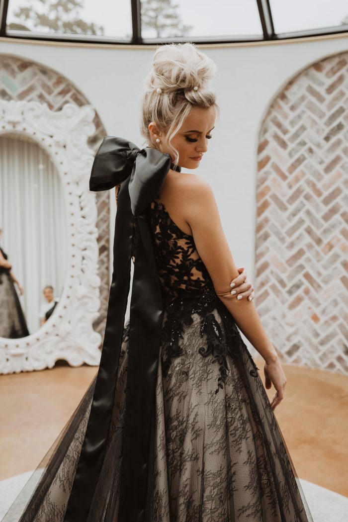 Bride wearing black wedding dress Zander by Sottero and Midlgey instead of white, which is a wedding tradition