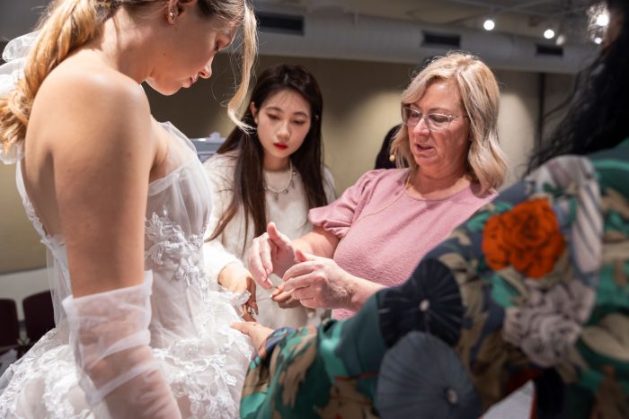 Kelly Midgley and a model wearing a wedding dress designed by Otis students during upcycling mentorship project