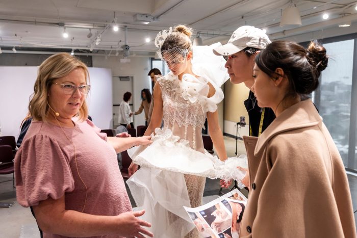 Kelly Midgley and a model wearing a wedding dress designed by Otis students during upcycling mentorship project