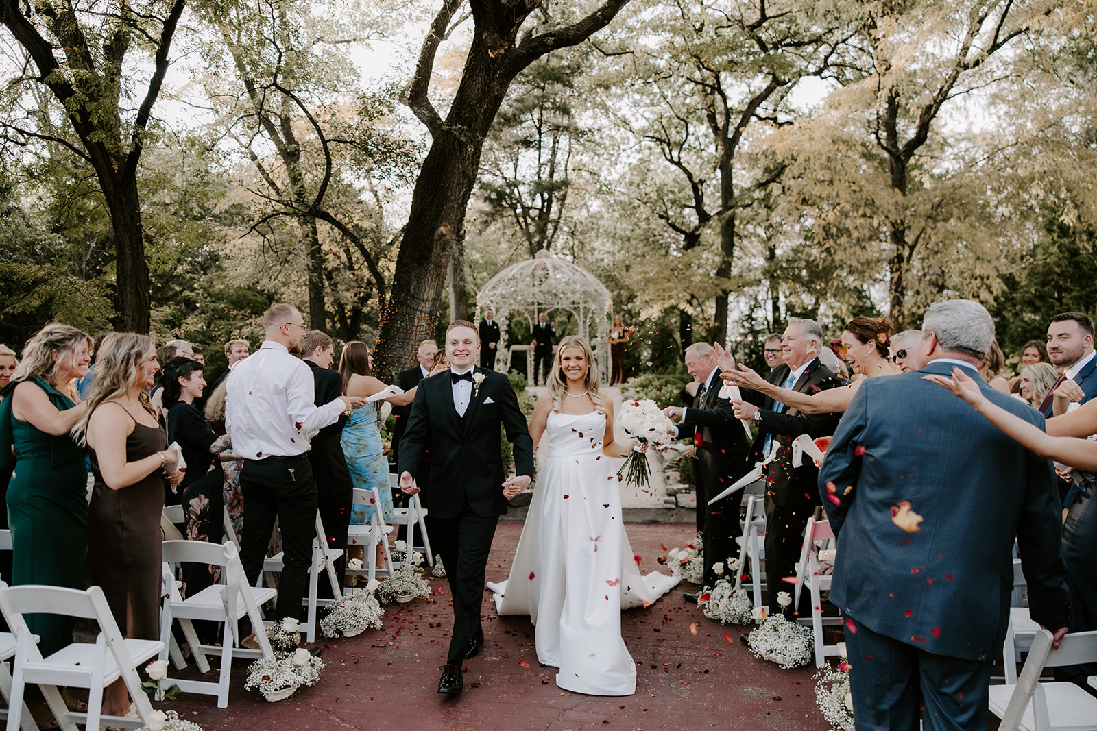 Bride wearing Aspen by Sottero and Midgley walking down the aisle with her groom