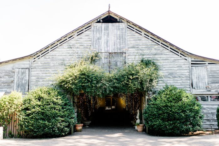 Barn venue with fairy lights and greenery
