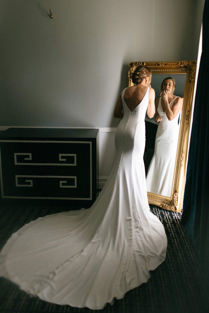 Bride wearing Fernanda by Maggie Sottero checking her dress as part of her wedding dress checklist