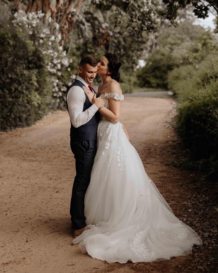 Bride wearing Harlem by Maggie Sottero with her husband staying stress-free