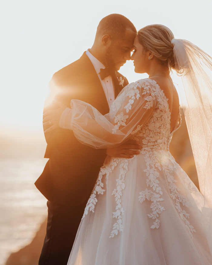 Bride wearing Alexandria long sleeve wedding dress by Maggie Sottero with her husband