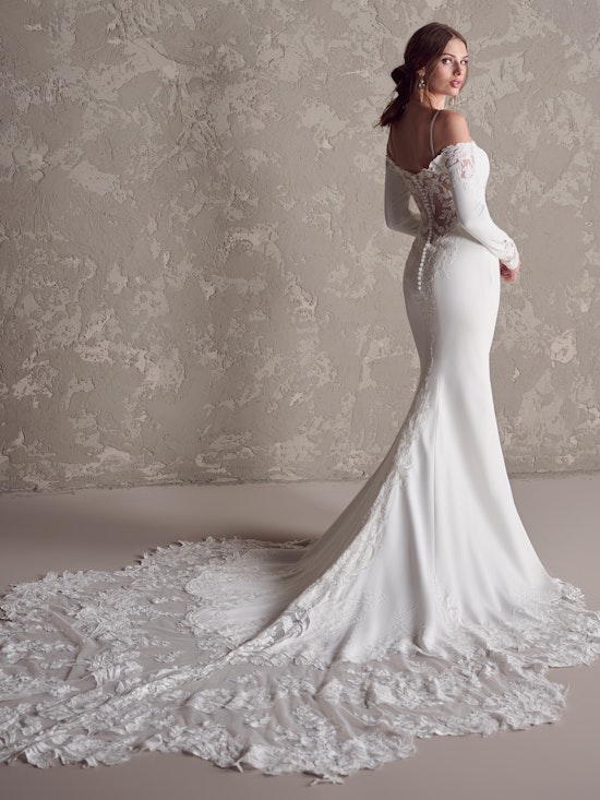 Bride wearing Tyra long sleeve wedding dress by Maggie Sottero