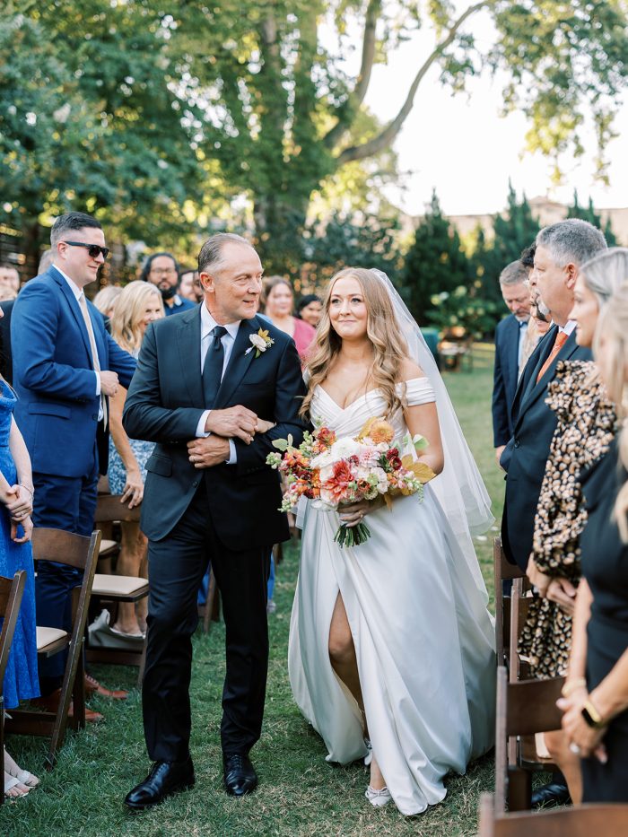 Bride wearing Ekaterina walking down the aisle with her father