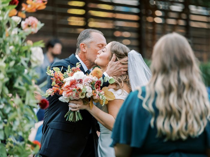 Bride wearing Ekaterina walking down the aisle with her father