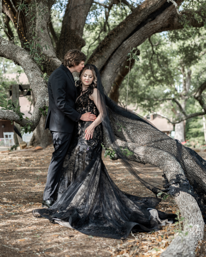 Bride wearing Zander Lane black wedding dress by Sottero and Midgley