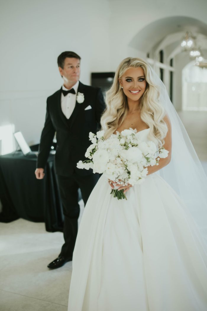 Bride wearing Derrick satin wedding dress by Maggie Sottero