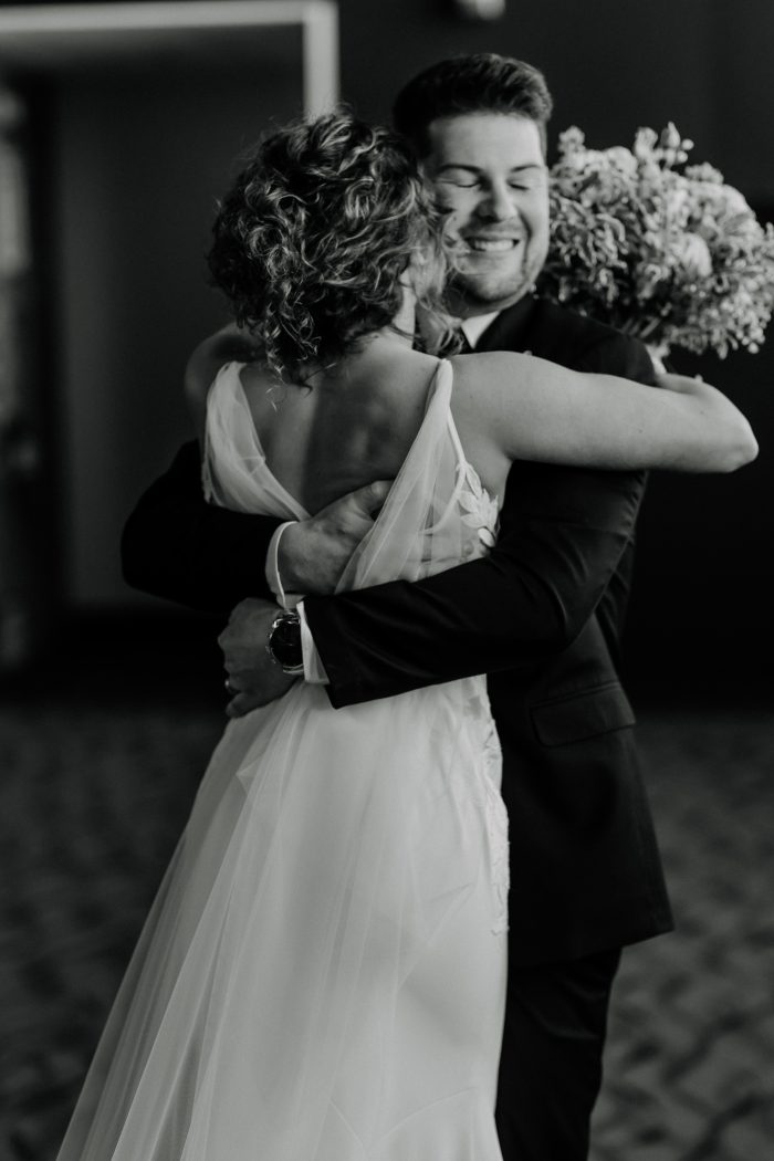 Bride wearing Dionne backless wedding dress by Rebecca Ingram