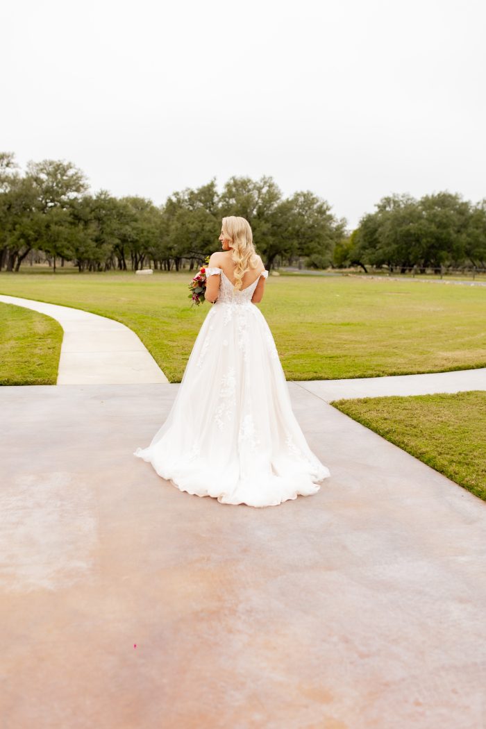 Bride wearing Harlem backless wedding dress by Maggie Sottero