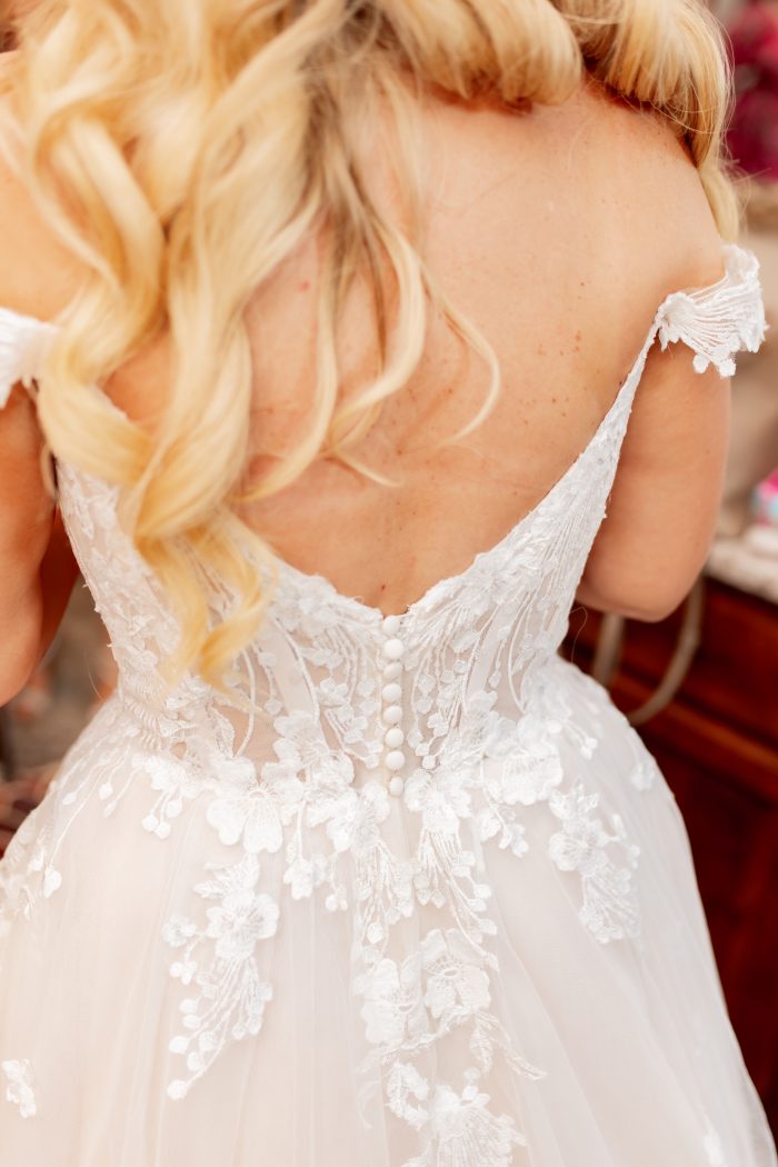 Bride wearing Harlem backless wedding dress by Maggie Sottero