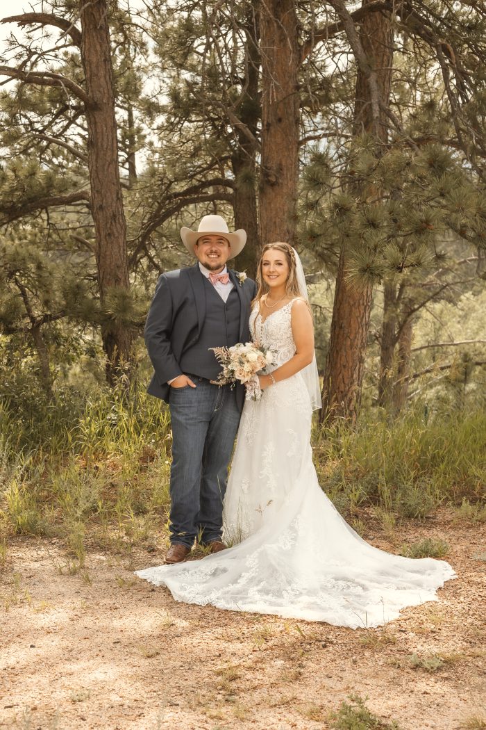 Bride wearing Johanna western wedding dress by Maggie Sottero with her husband