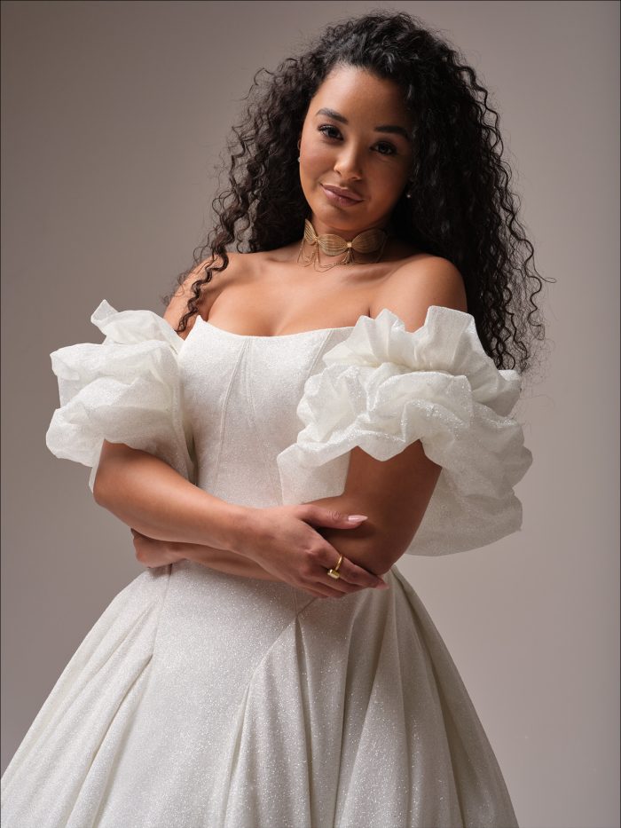 Bride wearing puff sleeves with her sparkly basque waist wedding gown