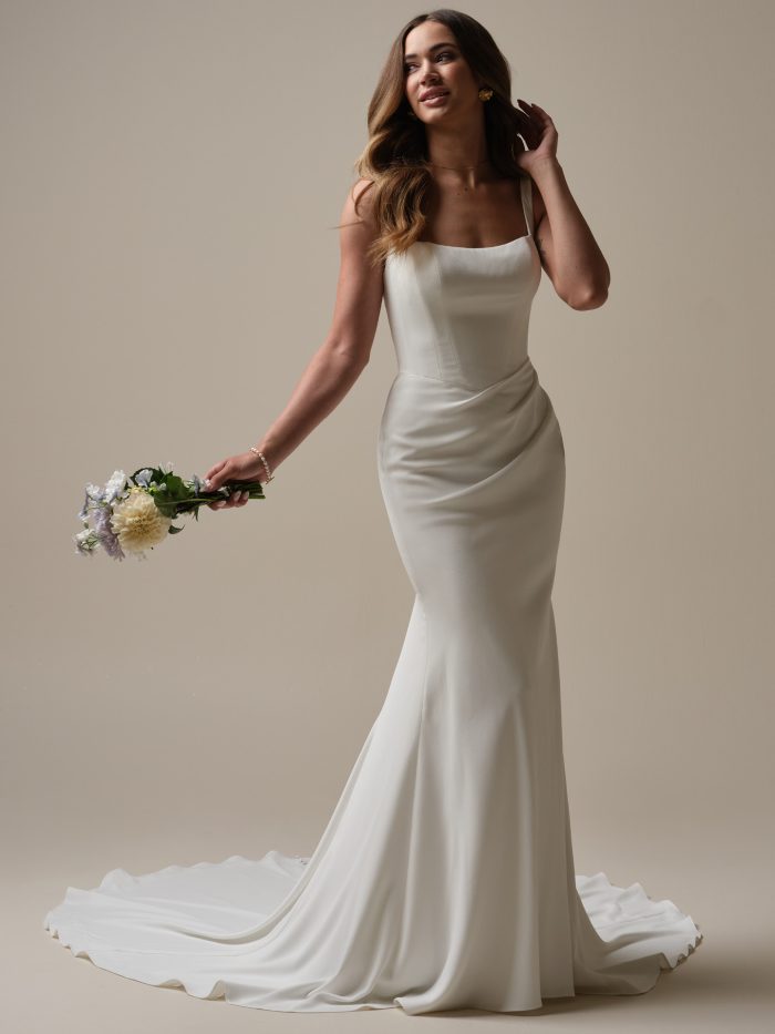 Bride wearing an affordable sheath wedding dress with pleating