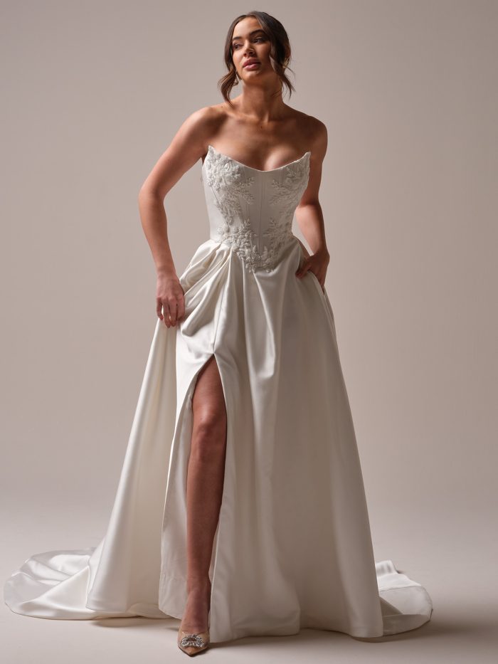 Bride showing leg slit in a glamorous A-line wedding dress