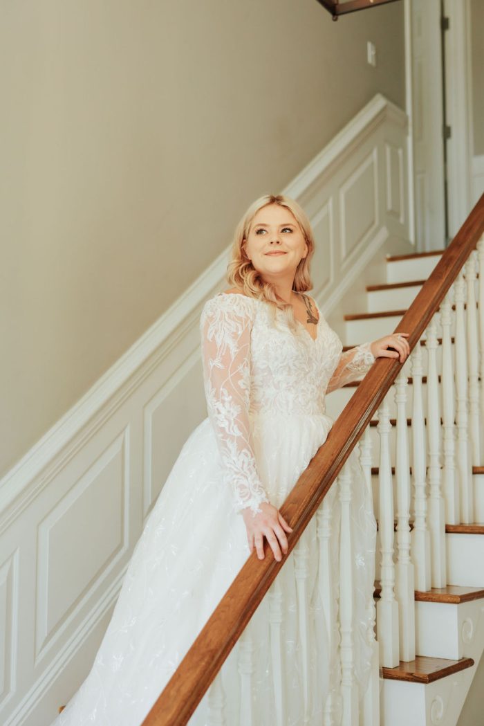 Brittany wearing one of Maggie Sottero's maternity wedding dresses on the steps