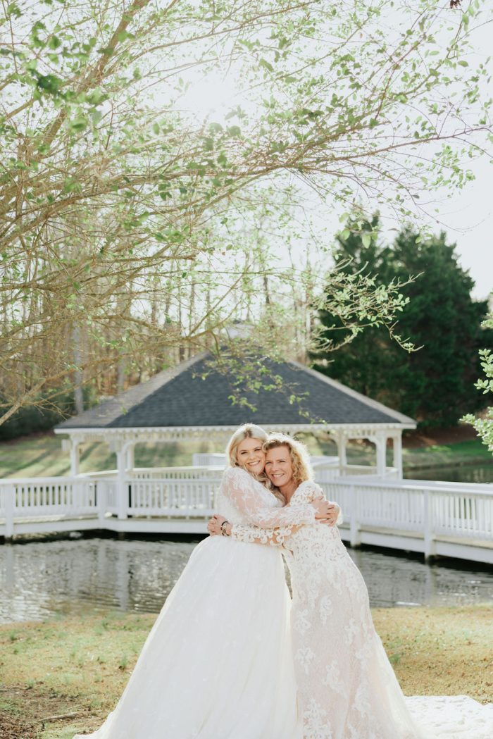 Brittany wearing one of Maggie Sottero's maternity wedding dresses and her mom embracing