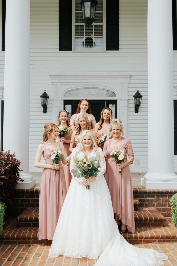 Brittany wearing one of Maggie Sottero's maternity wedding dresses with her bridesmaids