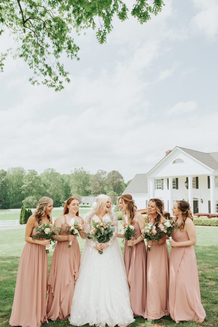 Brittany wearing one of Maggie Sottero's maternity wedding dresses with her bridesmaids