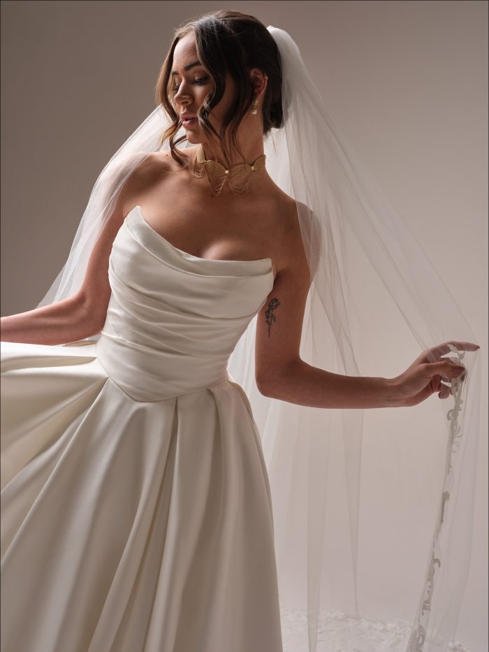 Bride wearing a simple wedding dress with a simple bridal veil