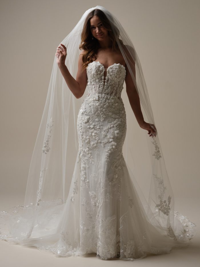 Bride playing with her bridal veil wearing a fit and flare wedding gown
