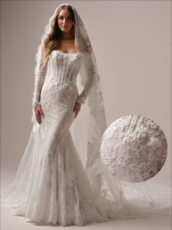 Bride wearing the Takera by Maggie Sottero, a lace fit-and-flare wedding dress with a structured corset bodice, long illusion lace sleeves, a sweetheart neckline, and a cathedral-length lace veil, photographed in a neutral studio setting.