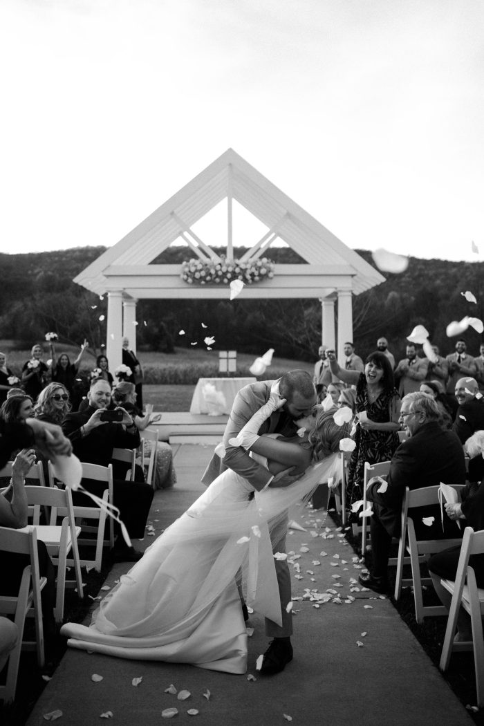 Bride wearing Mitchell by Maggie Sottero with her husband