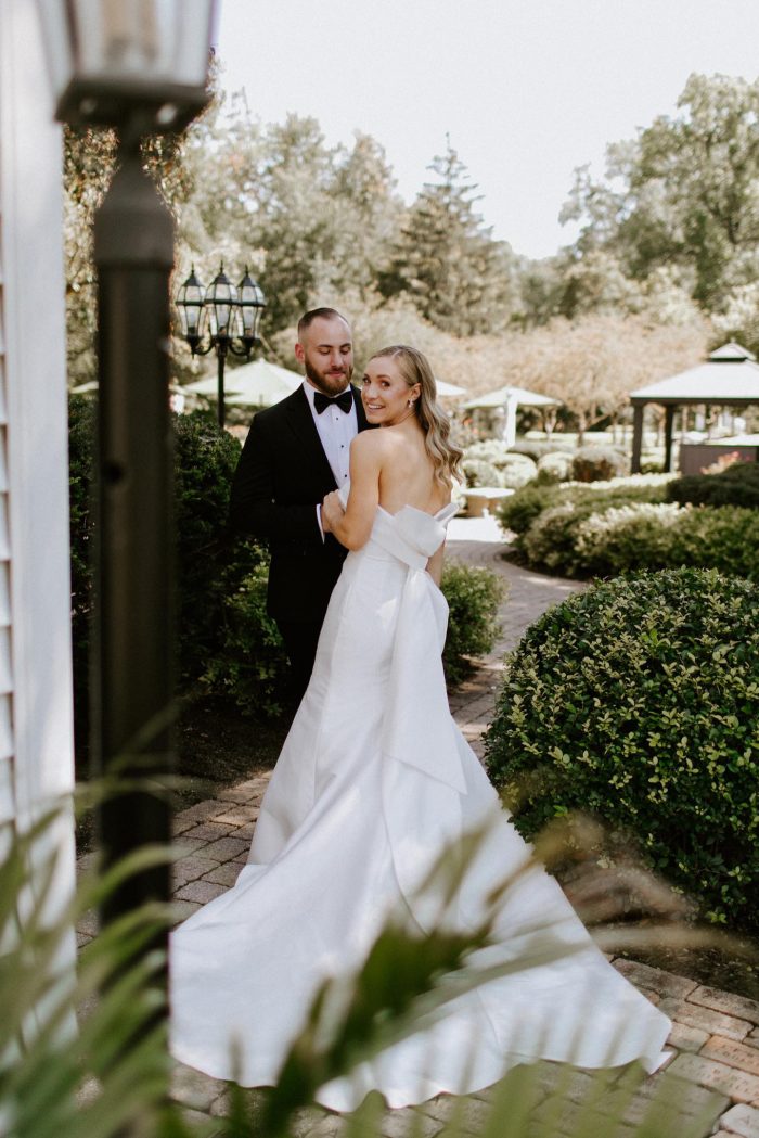 Bride wearing Mitchell by Maggie Sottero with her husband