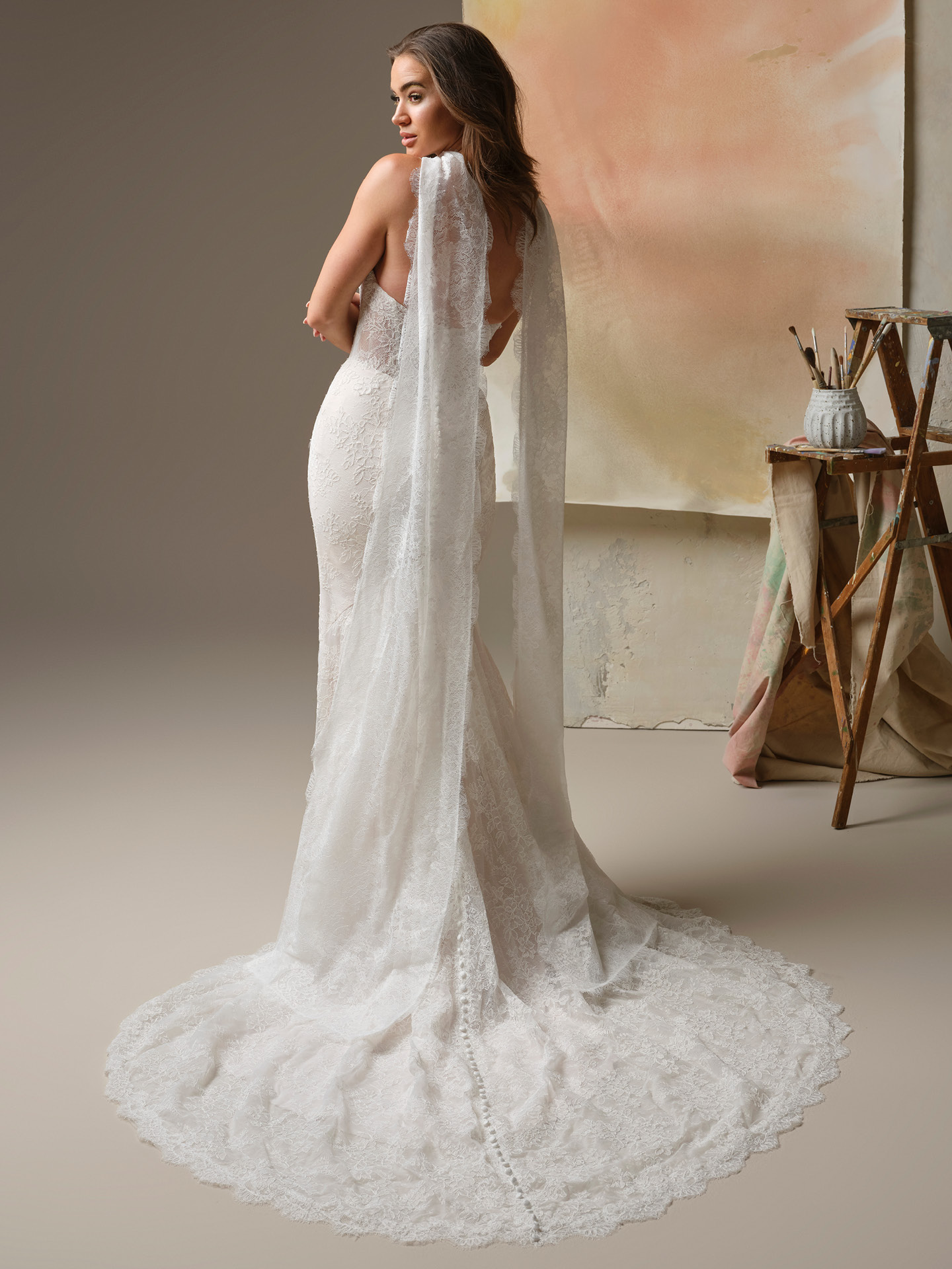 Back view of a lace shoulder wrap cascading into long, flowing panels for an ethereal, cape-inspired finish.