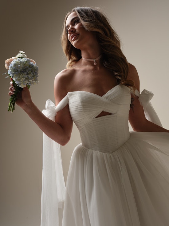 Bride wearing dress with wedding bows called Evan by Maggie Sottero